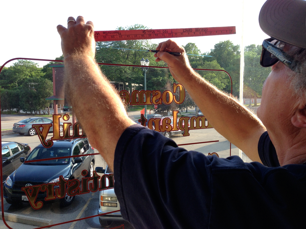 Larry Finishing Up a Window Sign